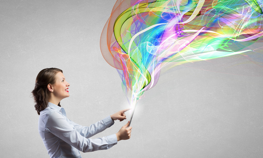 Attractive young woman using tablet and colorful lights out from device